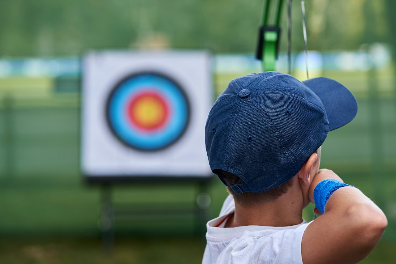 Child about to shoot an arrow at a target