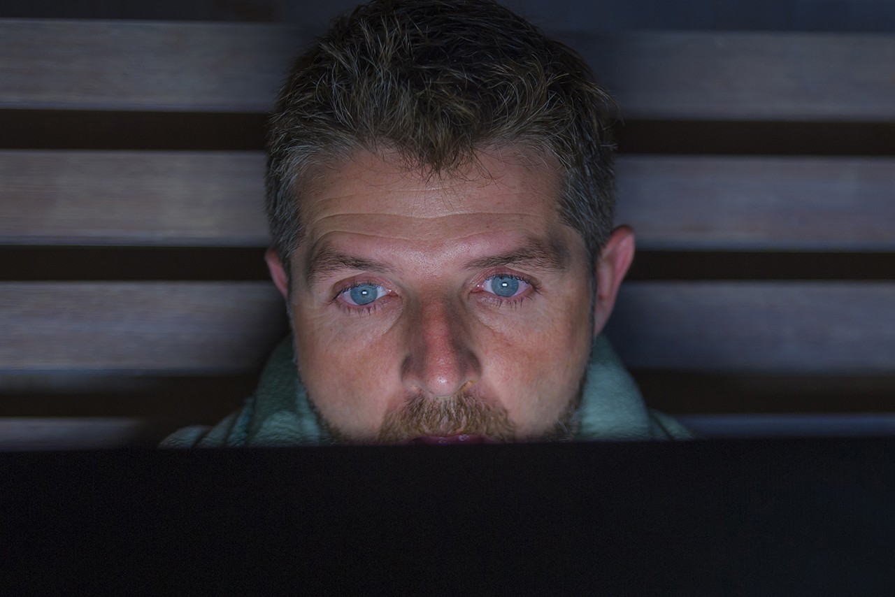 Man staring blankly at a laptop screen